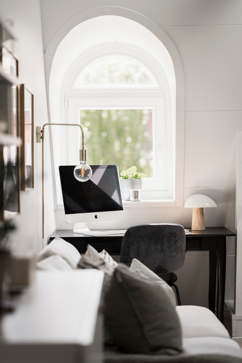 A Swedish Attic Apartment with a Lovely Balcony Overlooking the City 11 desk under dormer window