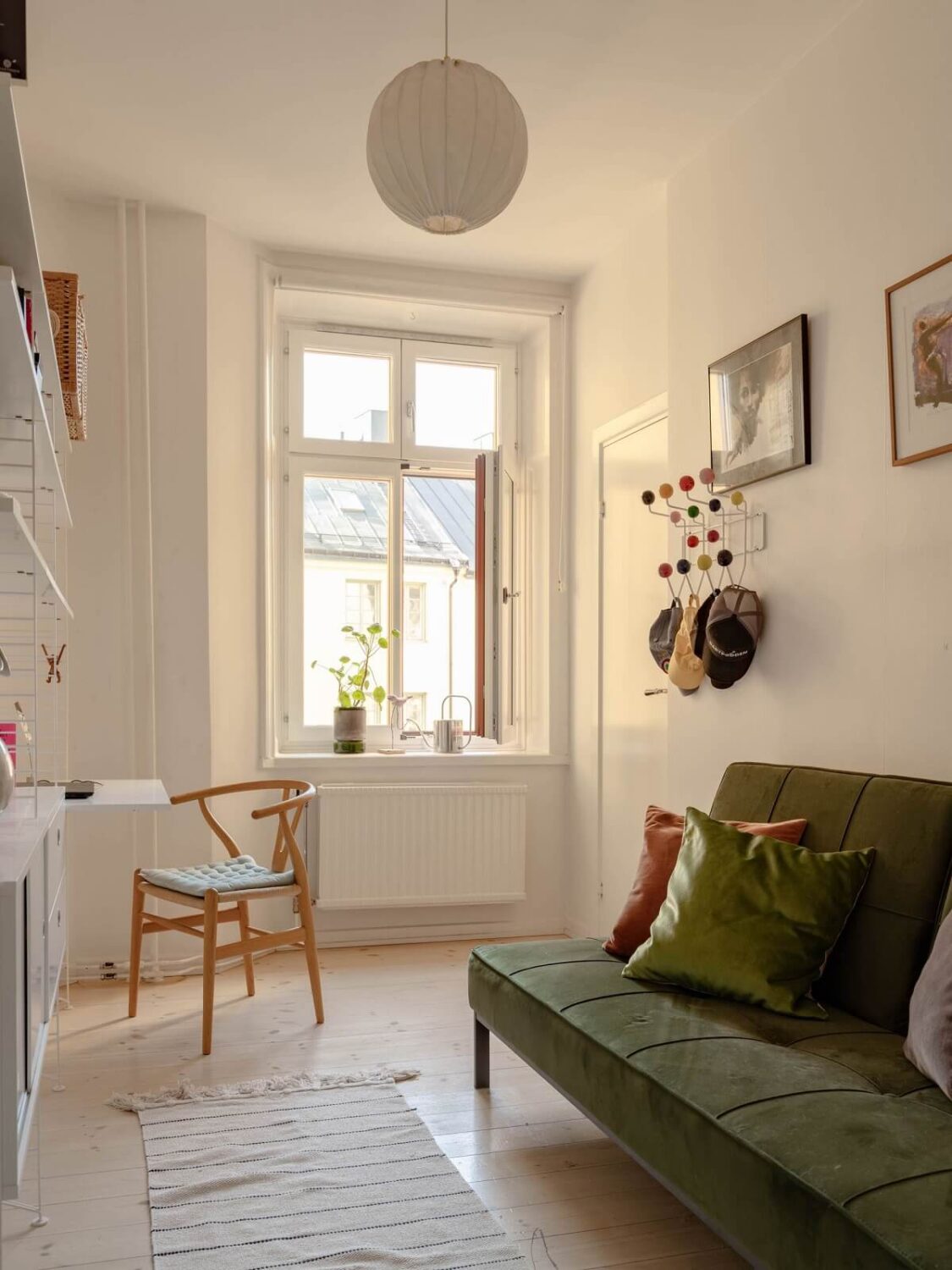 A Spacious Stockholm Apartment with Light Gray Walls 21 guest room with desk and green sleeper sofa A Spacious Stockholm Apartment with Light Gray Walls