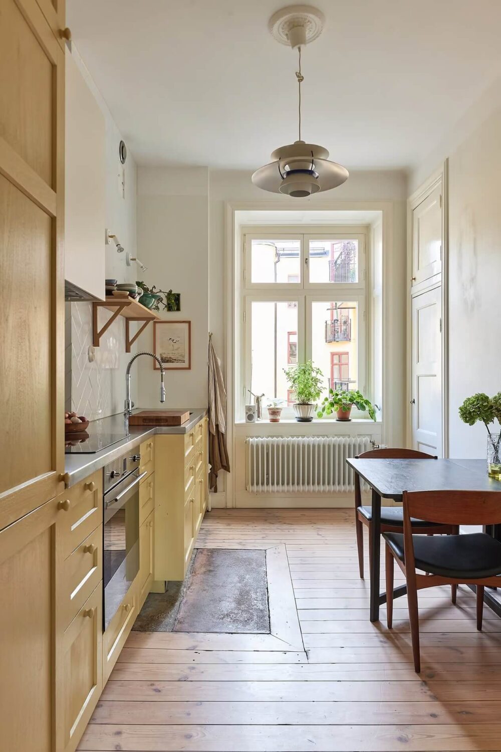 A Light Swedish Apartment with a Yellow Kitchen 14 kitchen with yellow cabinets