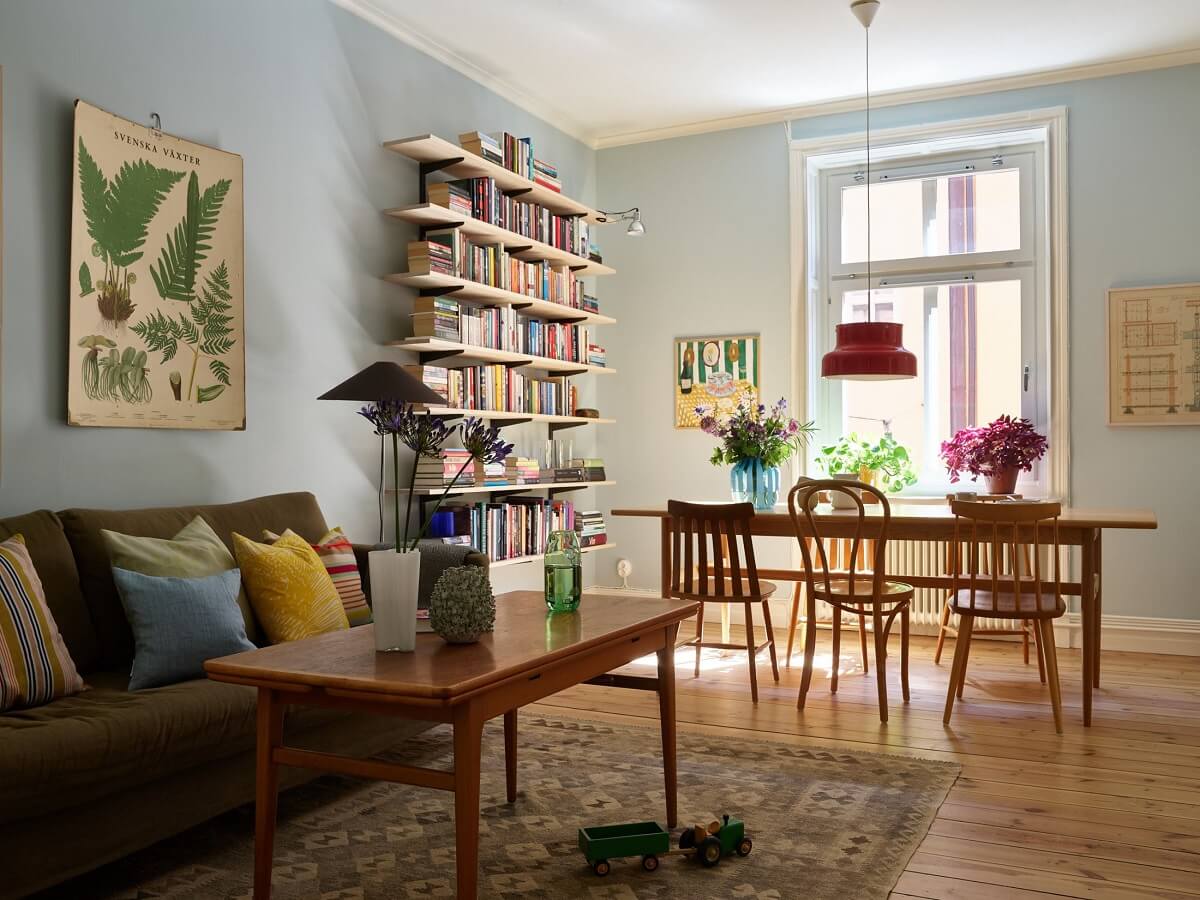 A Light Turn-of-the-Century Apartment with a Cheerful Color Palette 1 light blue living room wooden table with wooden floor