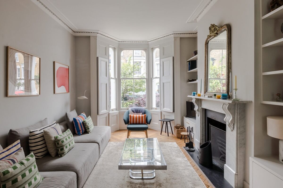 A Bright Extended and Renovated Victorian House in London 1 light gray living room with bay window and fireplace