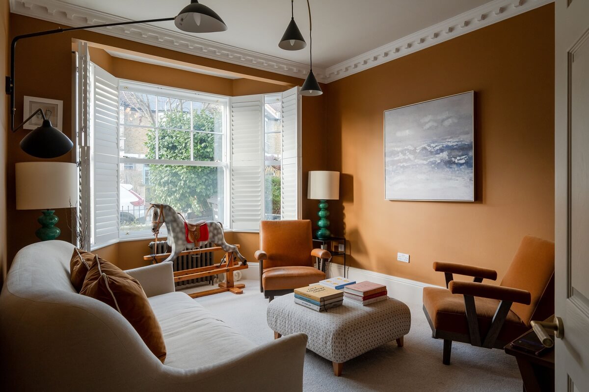 A Colorful Edwardian Family Home in London 1 living room paint and paper library rufus warm orange walls