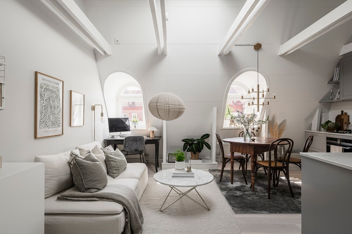 A Swedish Attic Apartment with a Lovely Balcony Overlooking the City 7 living room pitched ceiling exposed beams dormer window