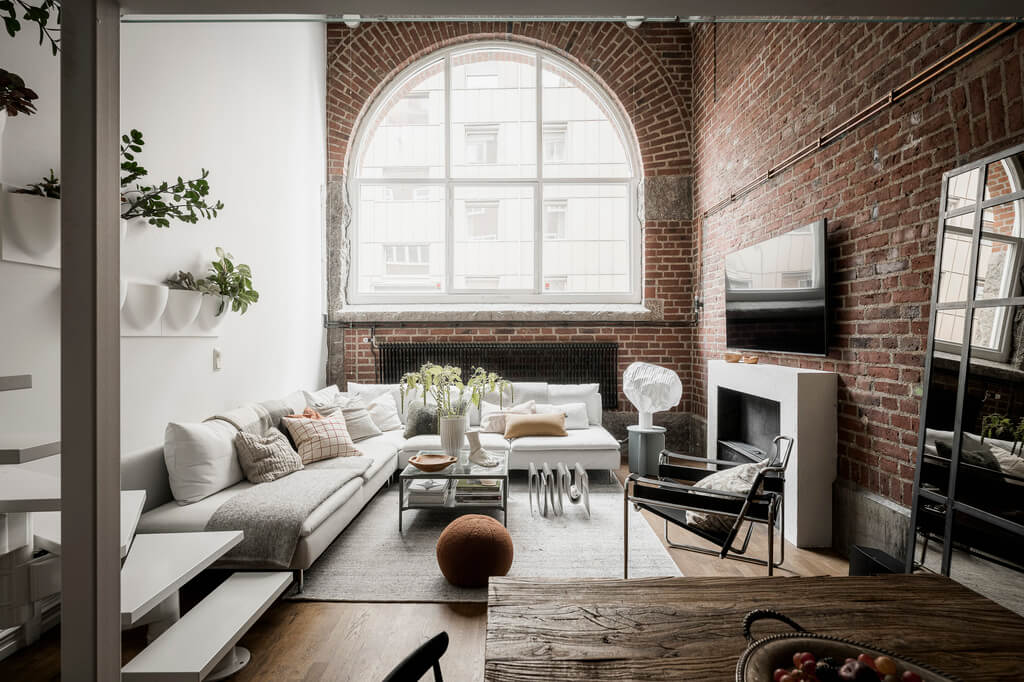 A Scandinavian Loft in an Old Industrial Building 1 loft with brick walls and large arched window