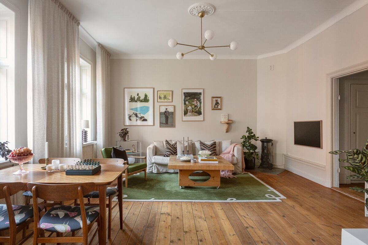 A Turn-of-the-Century Apartment with Warm Open-Plan Spaces 1 open plan living room with wooden floor and green rug