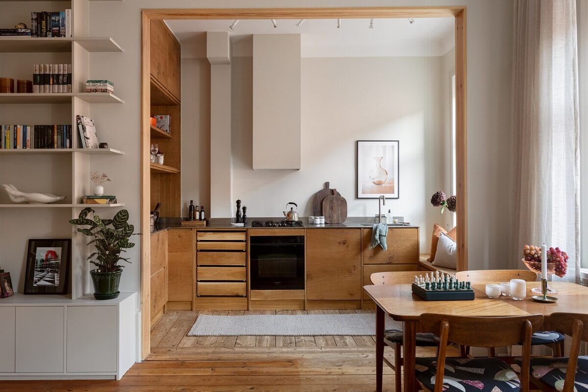 A Turn-of-the-Century Apartment with Warm Open-Plan Spaces 9 open plan living space with wooden kitchen