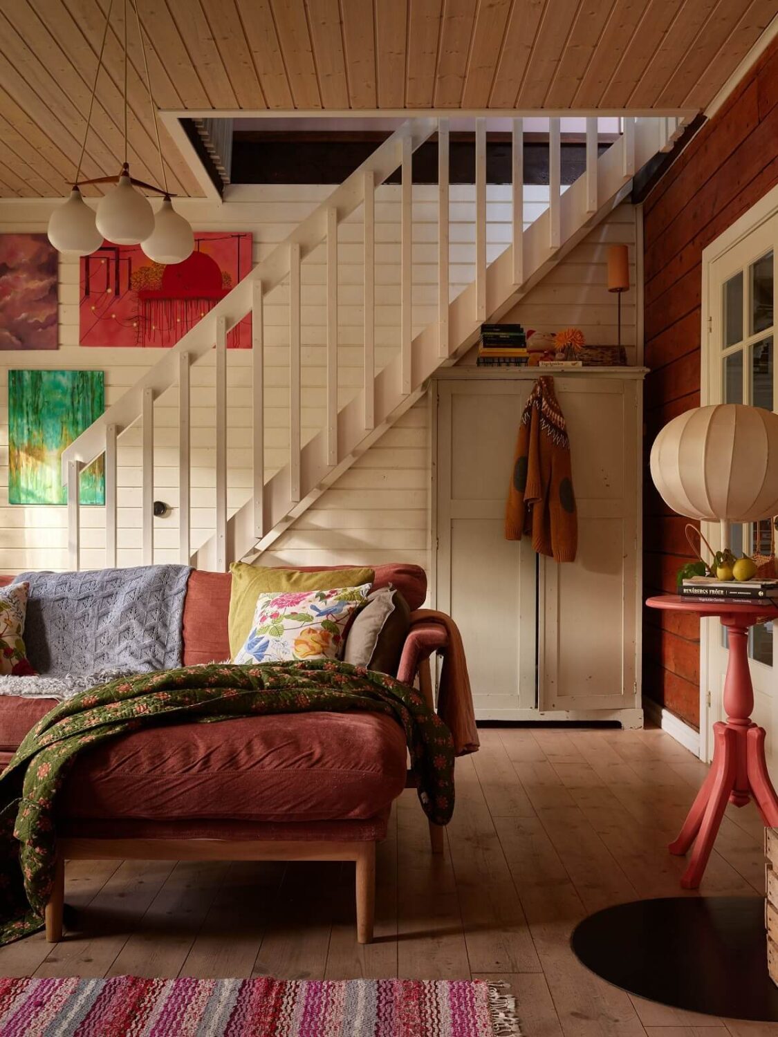 A Charming Swedish Cottage Filled with Art and Color 5 pink sofa living room