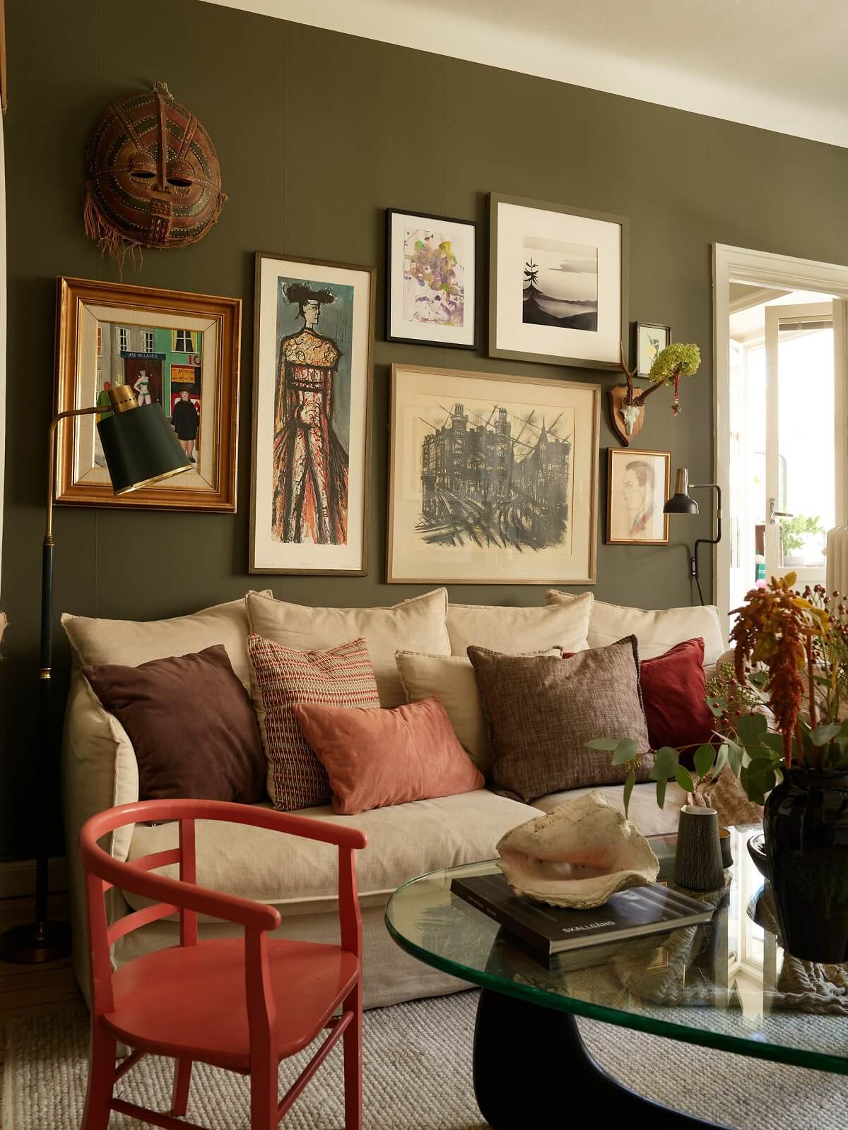 sitting room dark green wall with art