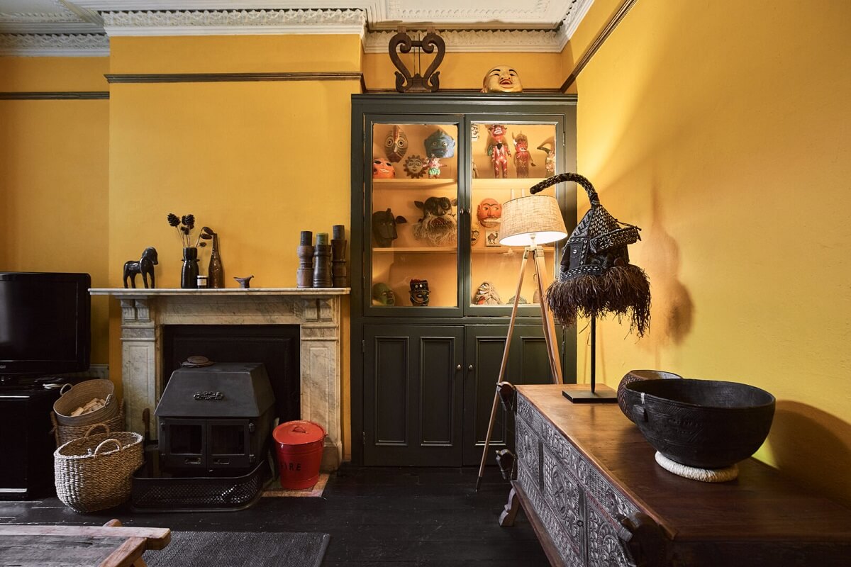 A Grand Victorian House with Many Period Features and a Lush Garden 11 yellow sitting room with dark floor and fireplace