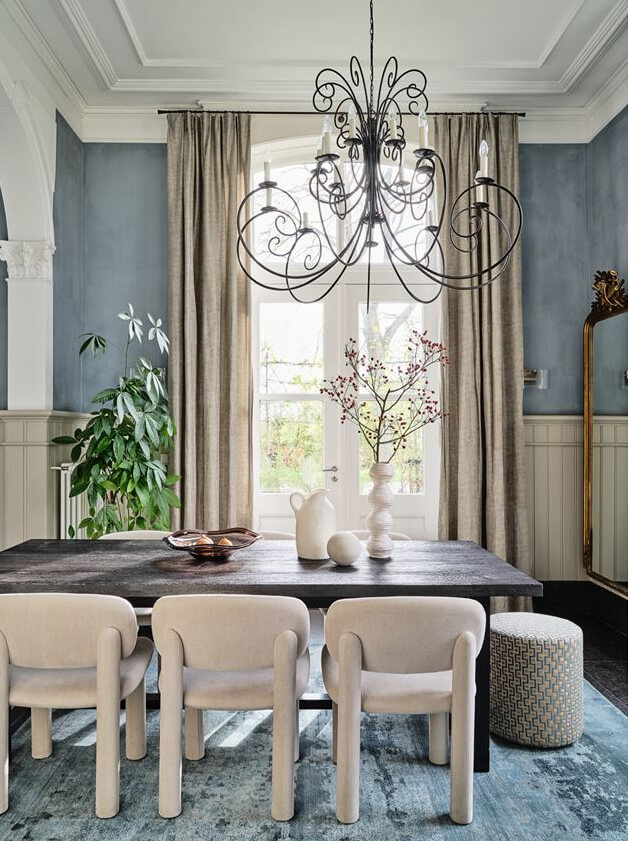 classic modern dining room with velvet chairs and large blue rug nordroom