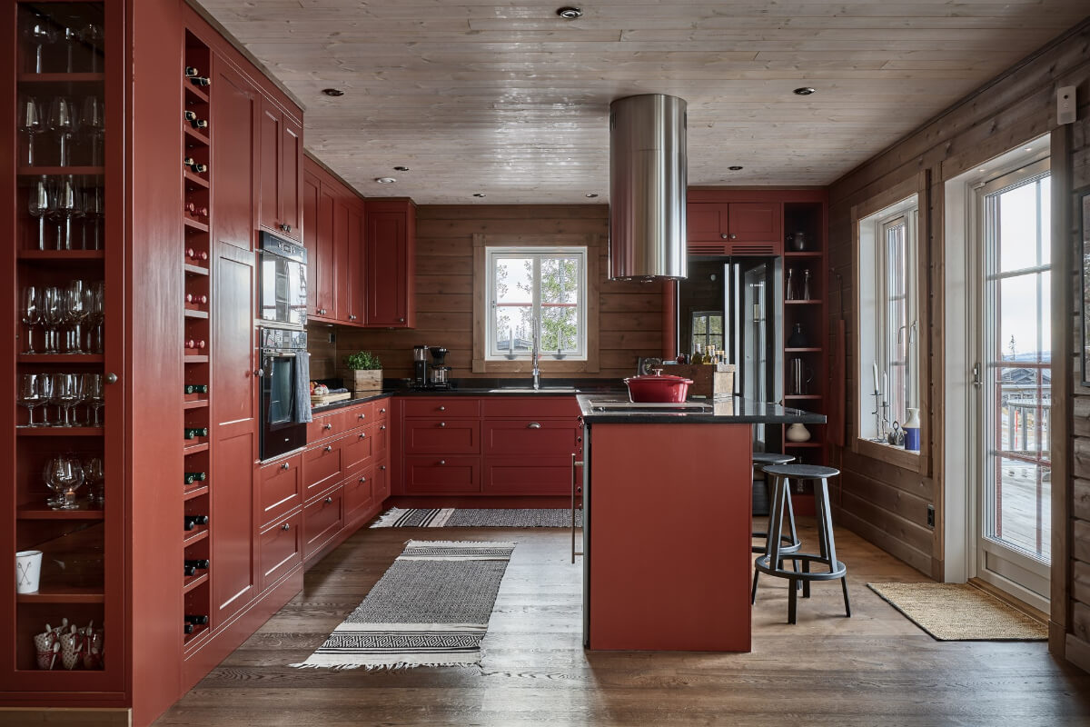 A Warm and Inviting Mountain House in Sweden 7 deep red kitchen in a swedish log house A Warm and Inviting Mountain House in Sweden