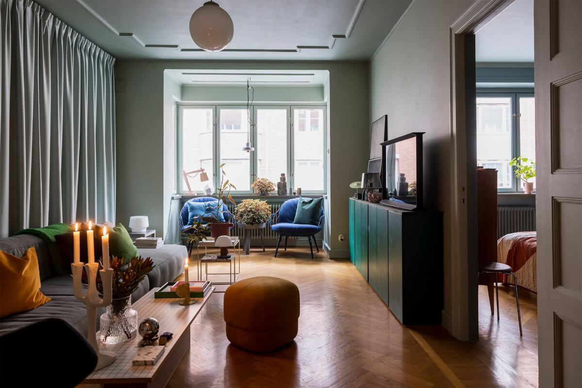 An Interior Designer's Moody Apartment with Period Features 1 gray living room with bay window and ochre yellow blue and green color accents