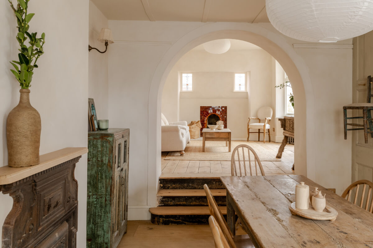 A Light Rustic Farmhouse-Style in an English Cottage 1 open plan living room dining room with split level floor plan rustic floorboards and farmhouse table nordroom