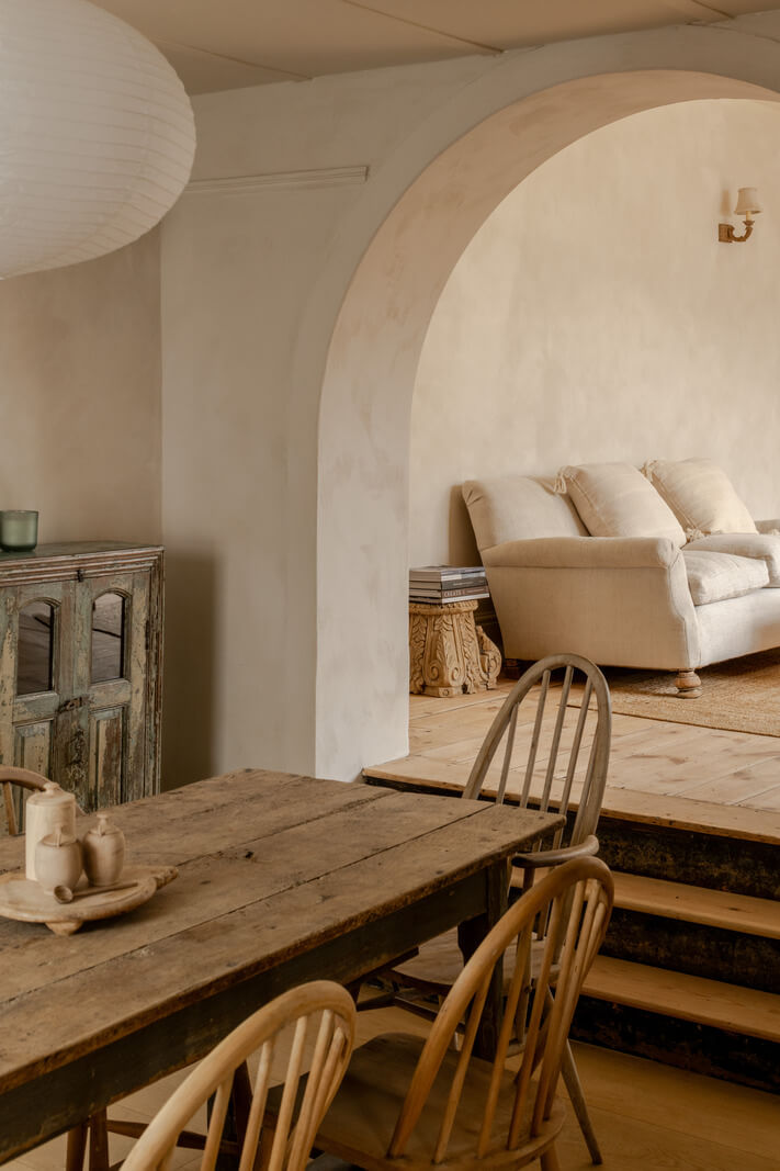 Best of 2025: Dining Rooms 43 rustic table in dining room with arched opening to living room nordroom