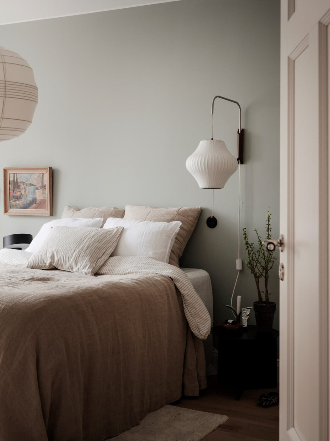 A Calm and Contemporary Apartment in a Former Office Space 15 scandi bedroom with large wall lamp and neutral bedding