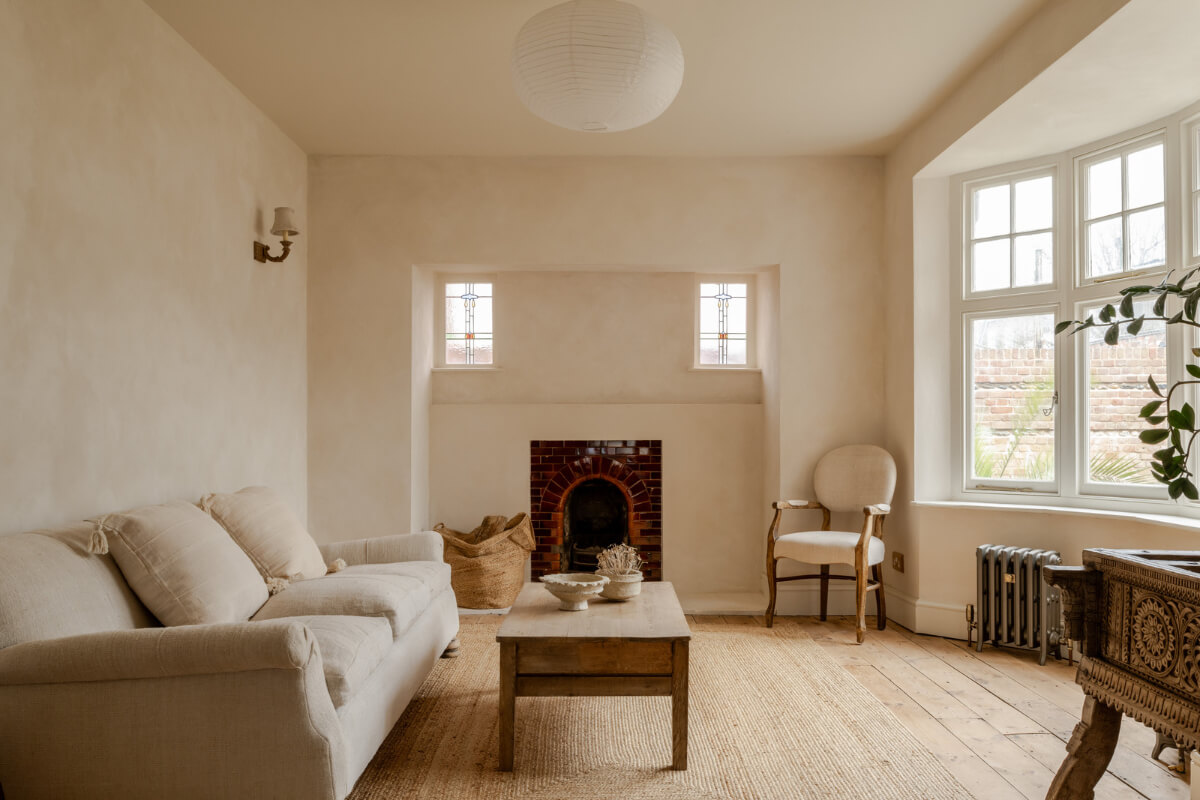 A Light Rustic Farmhouse-Style in an English Cottage 4 serene living room with bay window plaster walls and brick fireplace nordroom