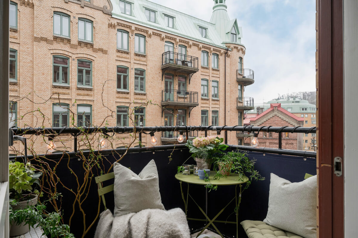An Early 20th-Century Apartment with a Pink Kitchen 18 balcony green bistro table