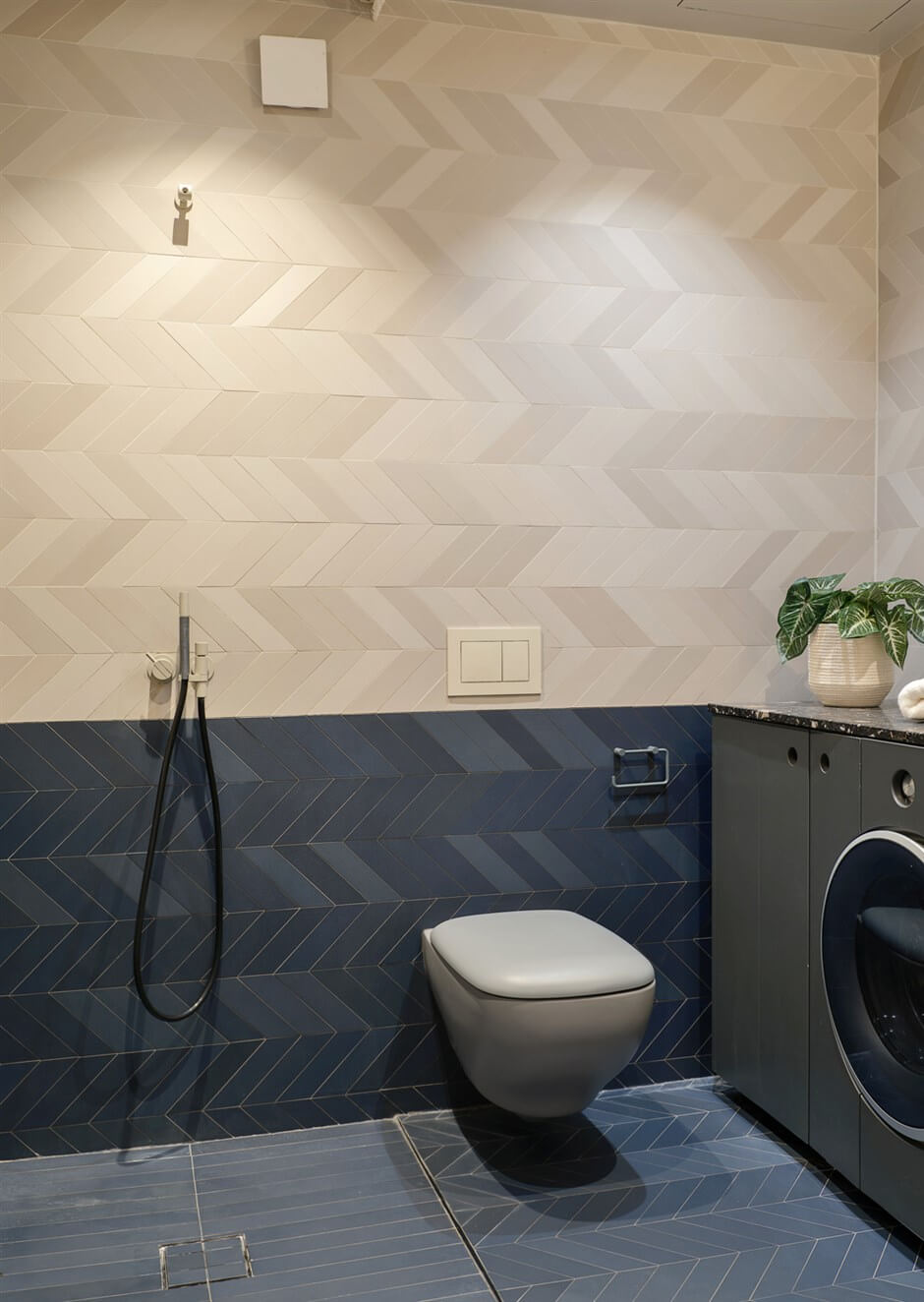 A Small Modern Stockholm Apartment with Smart Storage Solutions 19 bathroom two tone tile work chevron pattern