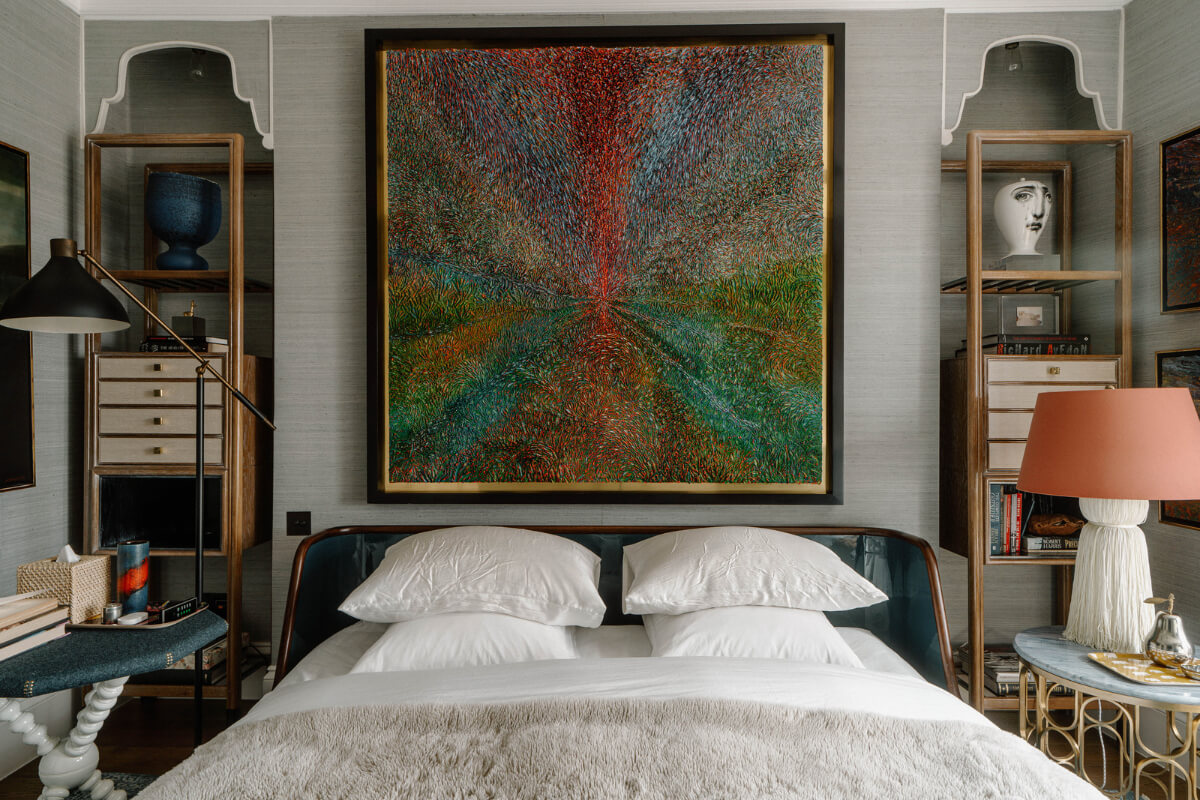 A Cozy Art-Filled Attic Apartment in London 17 bedroom with large art work above the bed