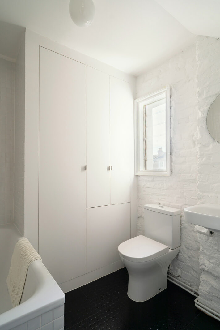 A Light One-Bedroom Apartment in a Victorian Terrace House 17 black and white bathroom exposed brick wall