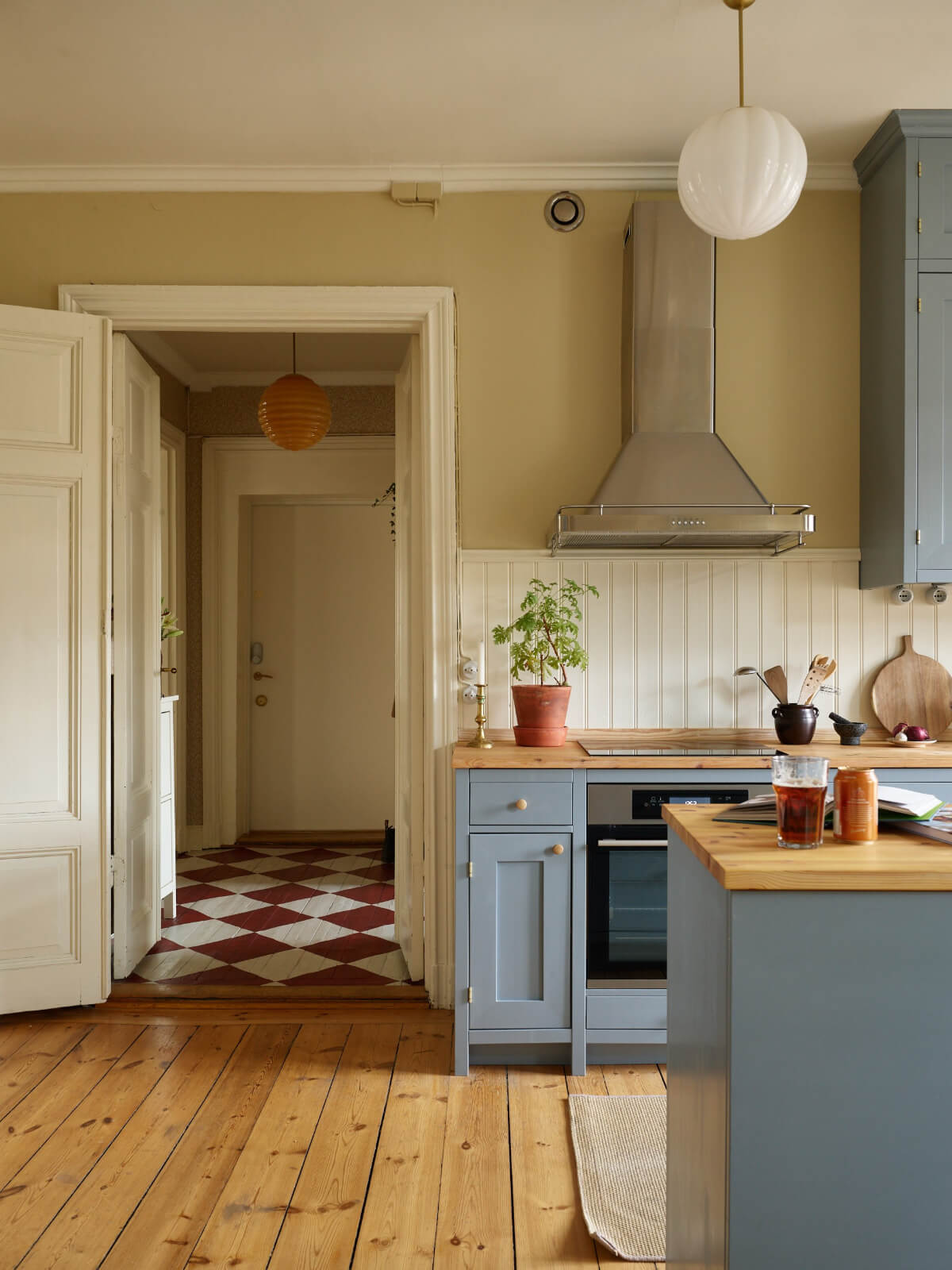 blue kitchen wooden floor view to hall with checkerboard floor