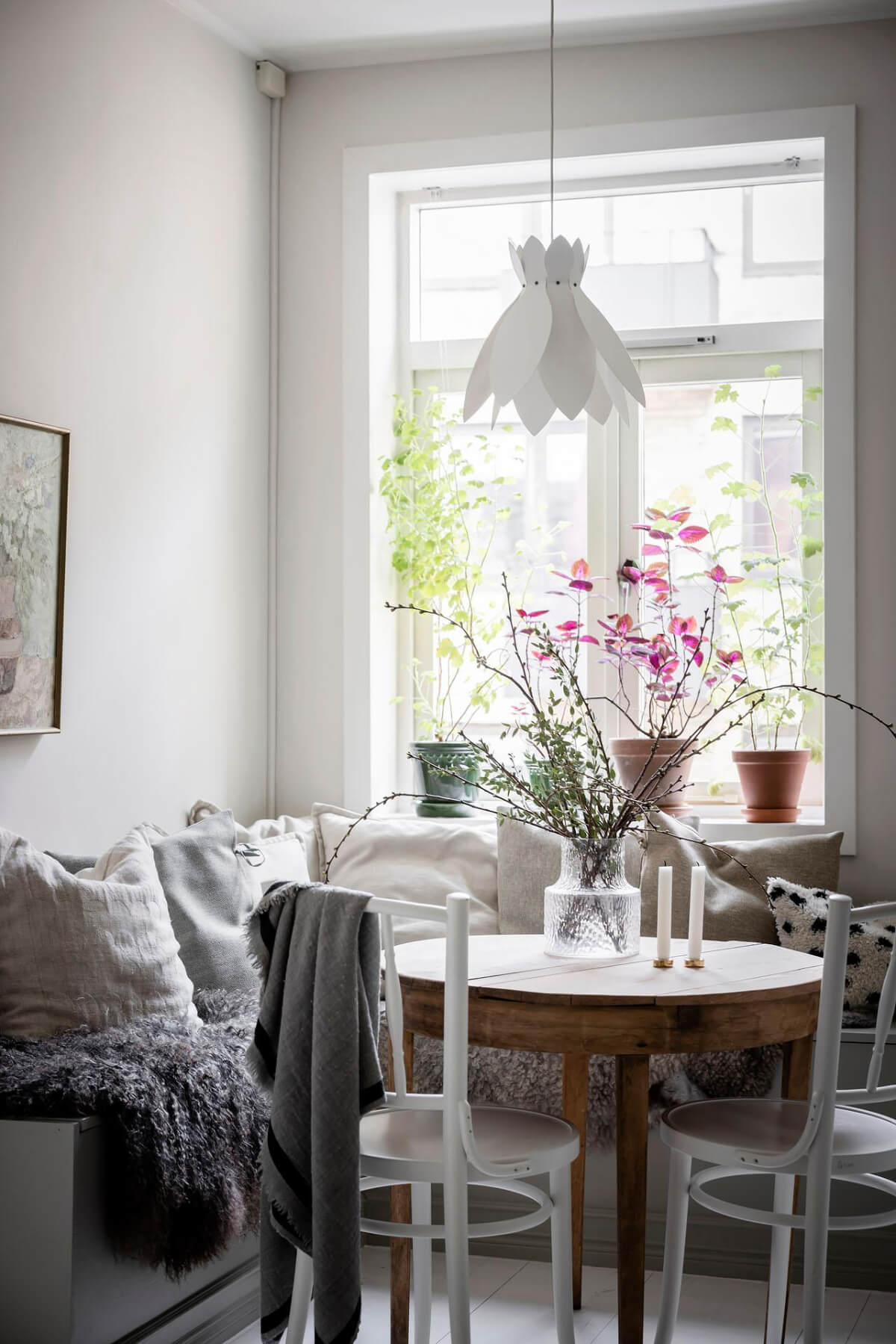 cozy breakfast nook layered textiles round wooden table