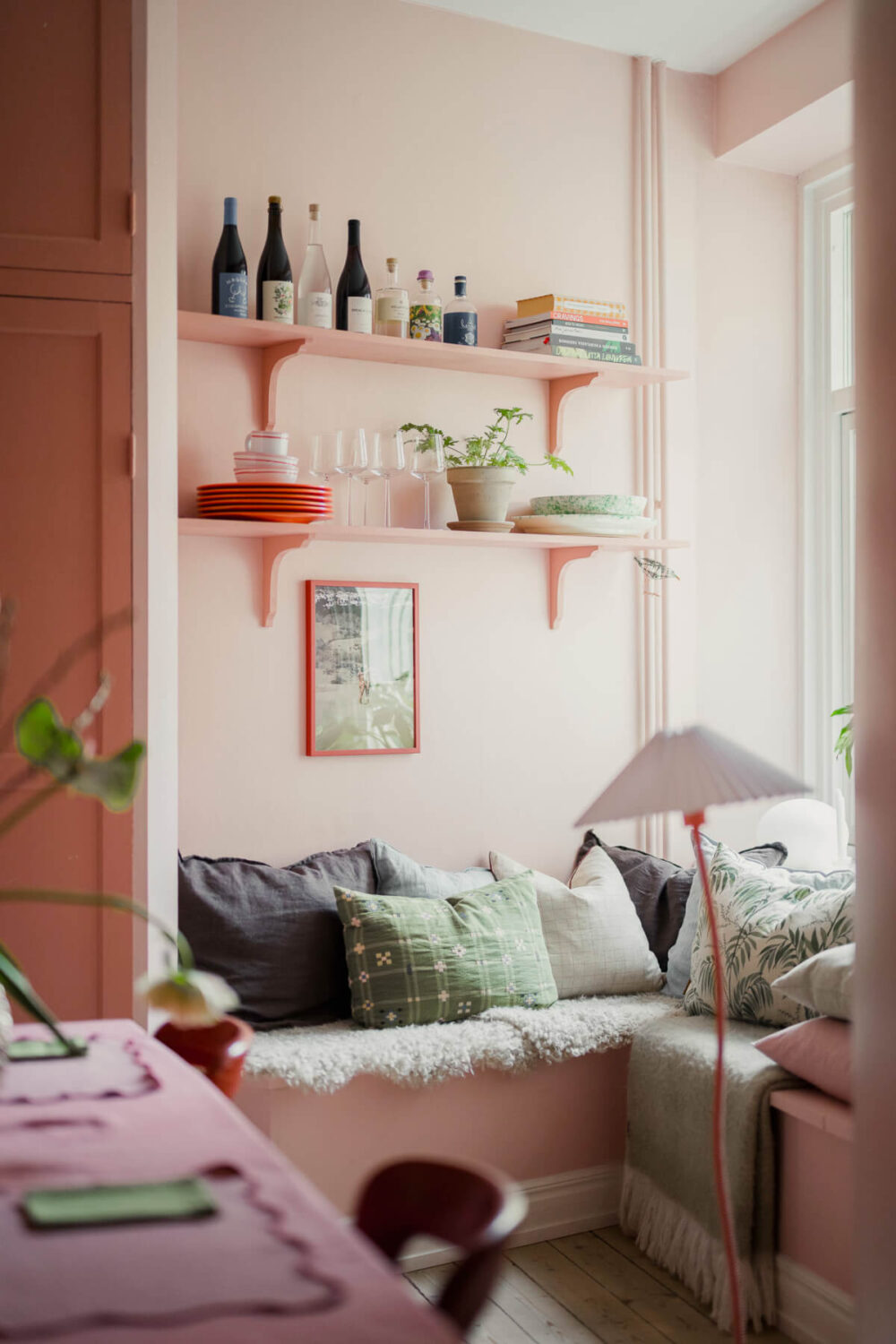 An Early 20th-Century Apartment with a Pink Kitchen 27 cozy window seat with shelves pink kitchen