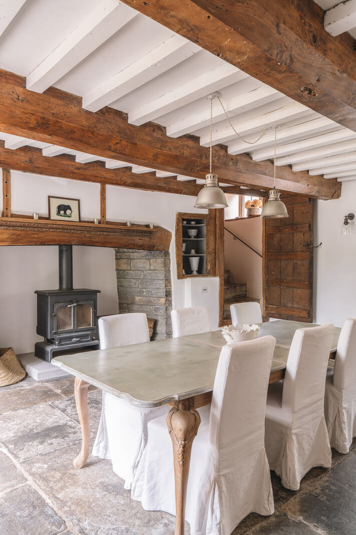 A Beautiful Renovated Country House in England 10 dining room wooden beams wood burner