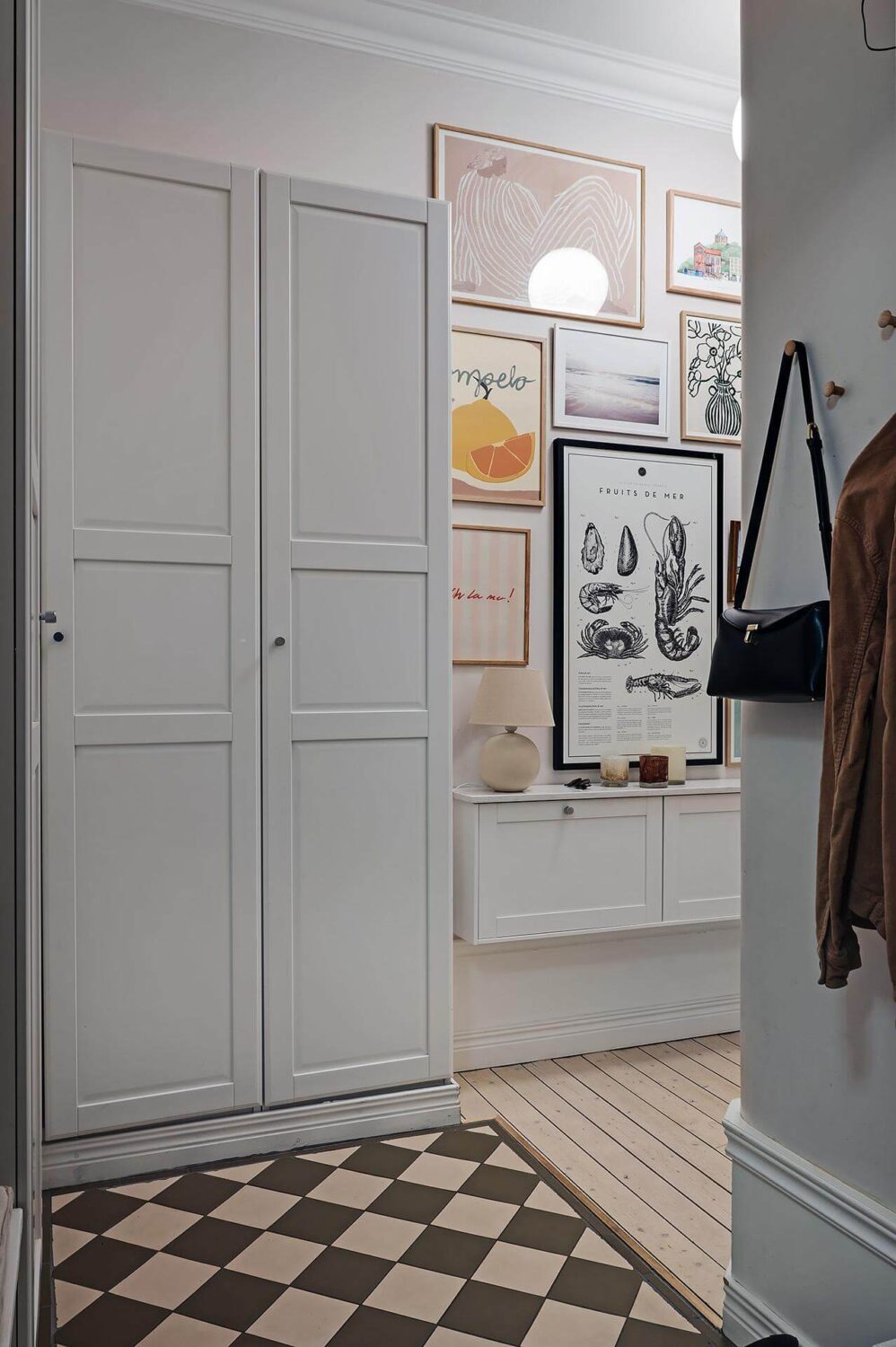Period Features and Modern Materials in a Swedish Apartment 33 hall storage checkerboard floor