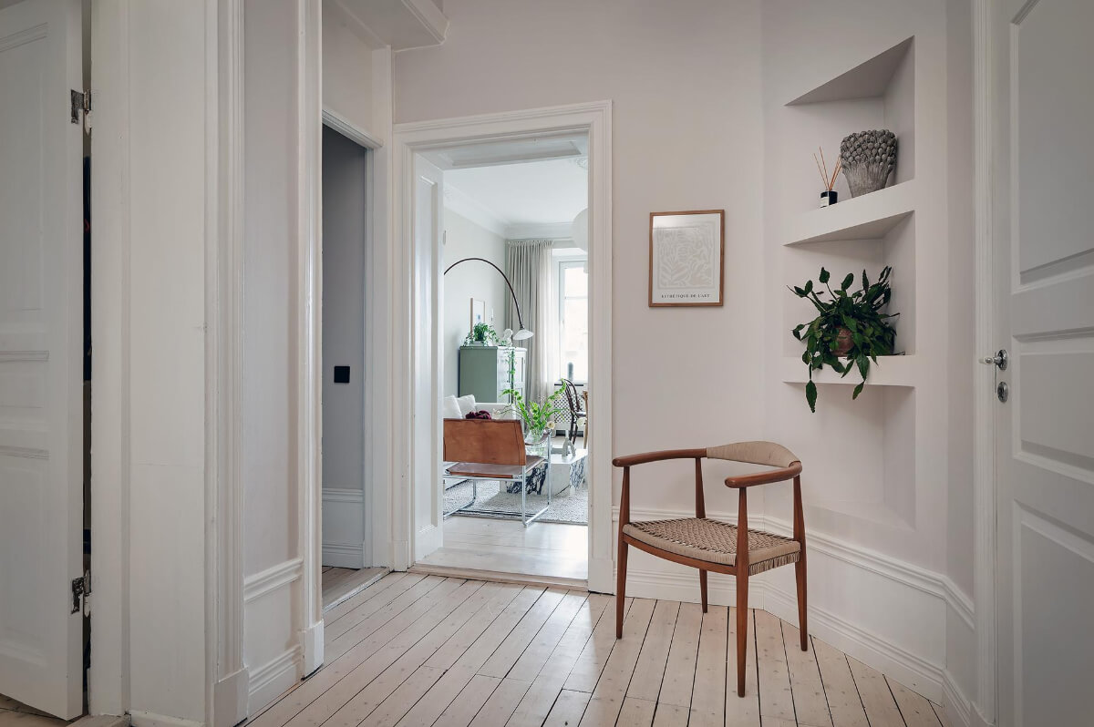 Period Features and Modern Materials in a Swedish Apartment 29 hallway corner shelves