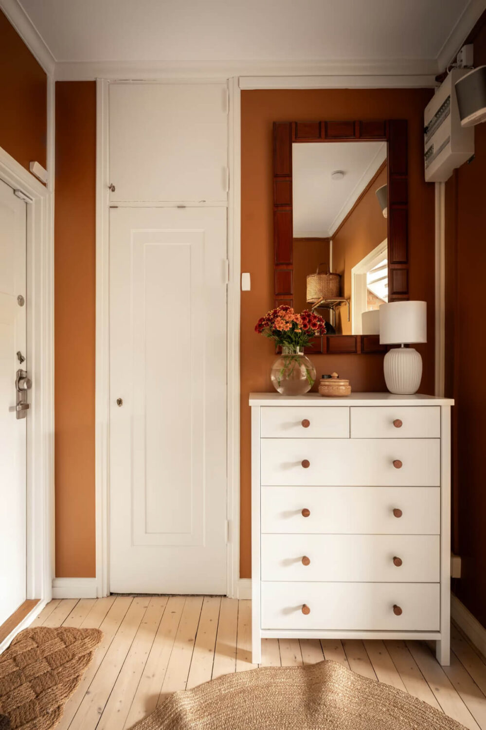 A Swedish Attic Apartment with Exposed Brick and Yellow Color Accents 21 hallway with brown walls