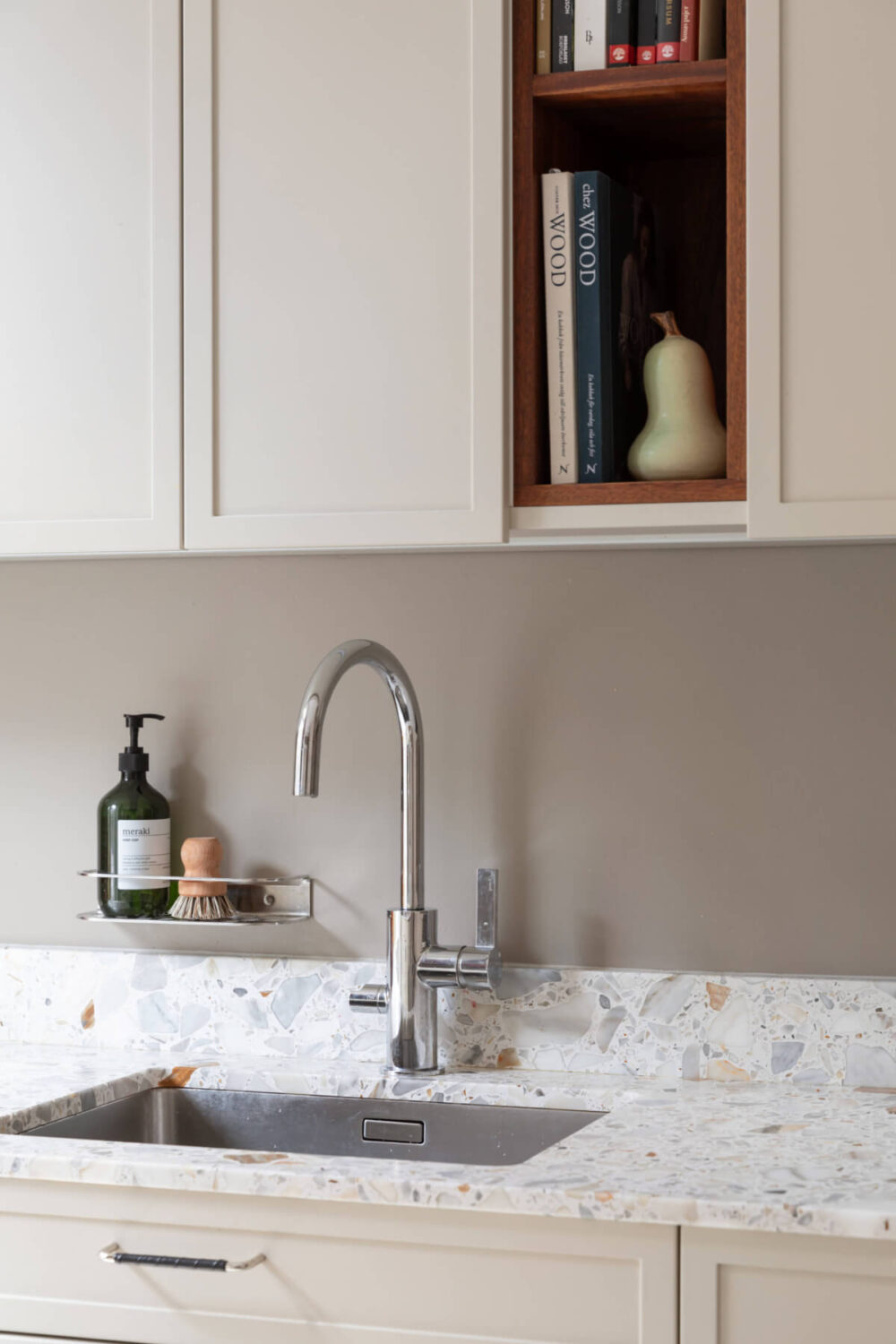 A Calm, Neutral Color Palette in a Classic Swedish Apartment 10 kitchen detail terrazzo worktop open cabinet nordroom