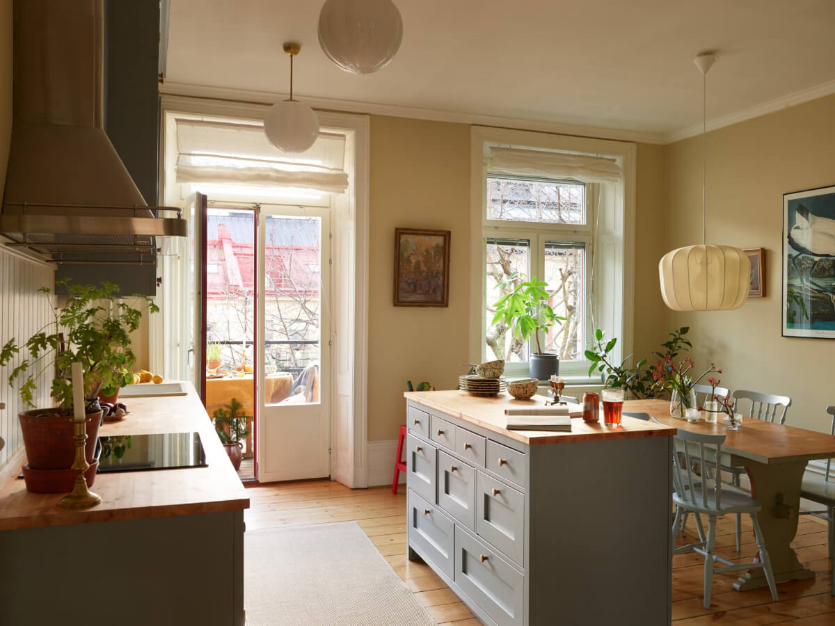 A Charming Historic Stockholm Apartment with a Blue Kitchen 1 kitchen with island and dining table