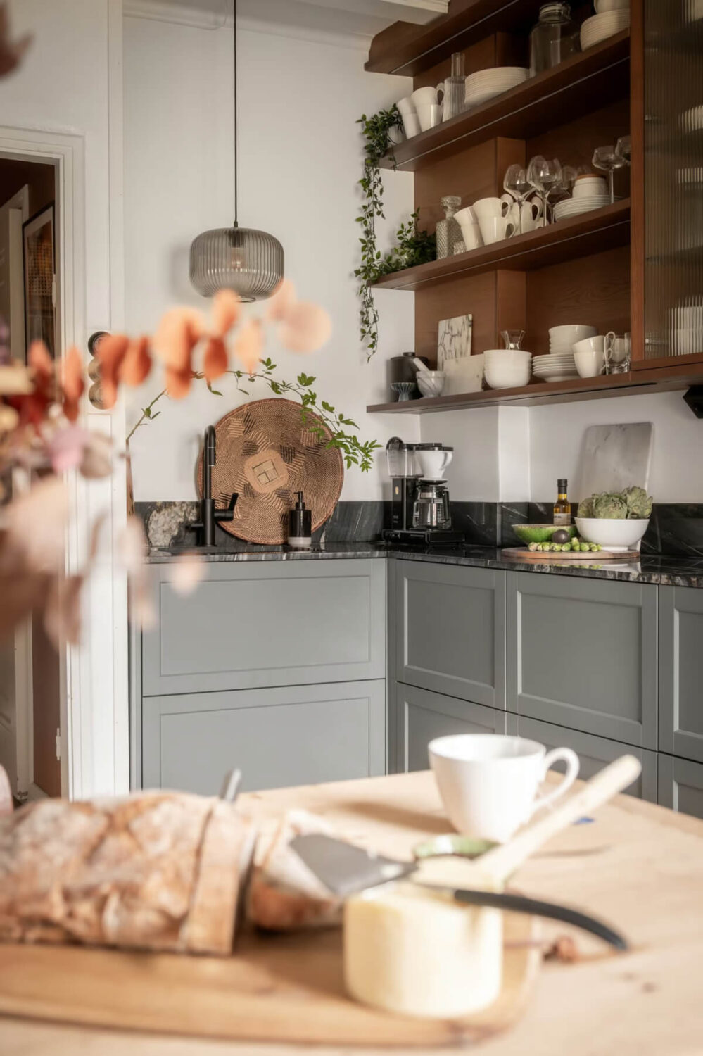 A Swedish Attic Apartment with Exposed Brick and Yellow Color Accents 9 kitchen with open and closed cabinets