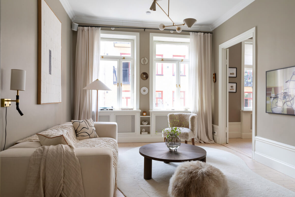 A Calm, Neutral Color Palette in a Classic Swedish Apartment 1 large windows sand colored walls scandi living room
