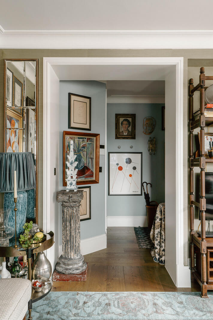 A Cozy Art-Filled Attic Apartment in London 20 light blue hall with art