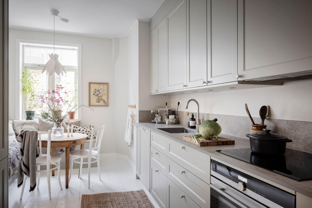 White-Painted Floorboards in a Turn-of-the-Century Apartment 11 light gray cabinets beakfast nook
