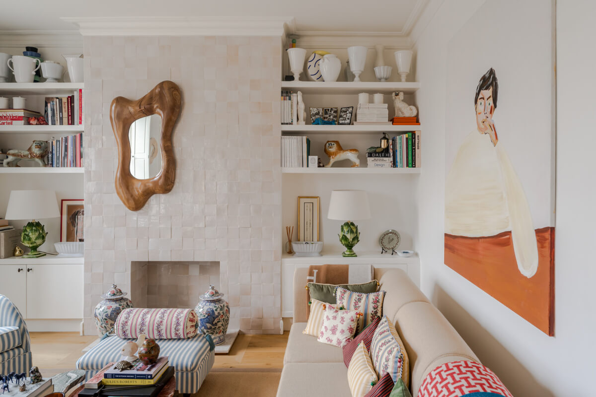 Cozy Contemporary Spaces in a Light-Filled Victorian Apartment 7 light living room floral patterned textiles zellige tiles fireplace mantel bookshelves
