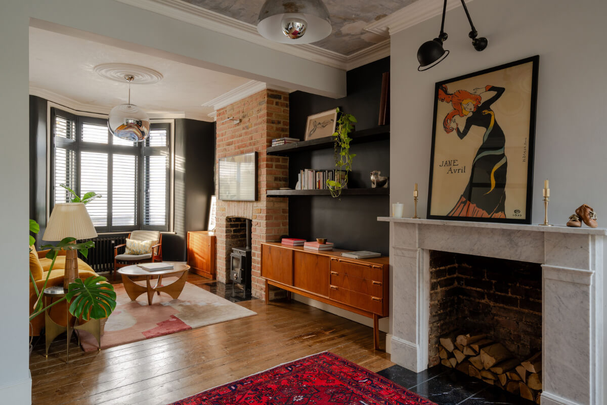 A Restored Victorian House with Exposed Brick and a Kitchen Extension 1 living room bay window black walls wooden floorboards fireplace