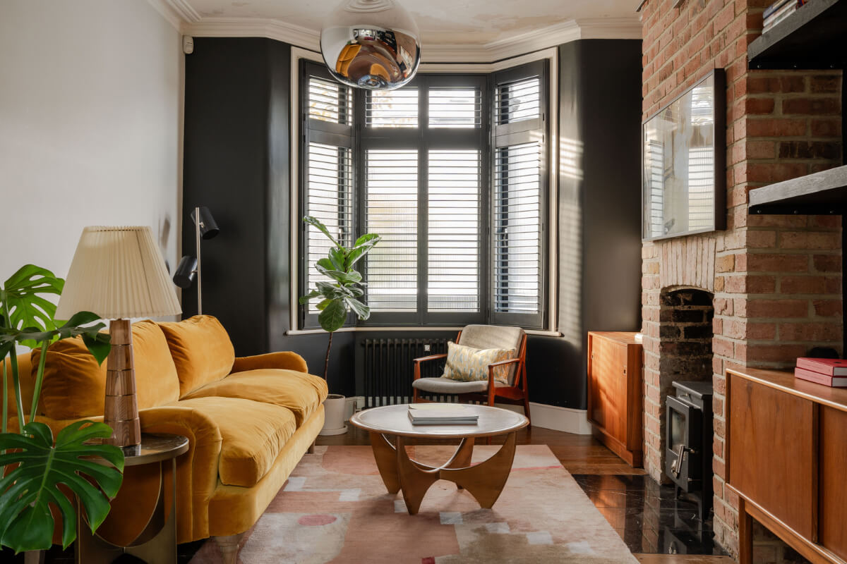 A Restored Victorian House with Exposed Brick and a Kitchen Extension 2 living room black bay window brick fireplace