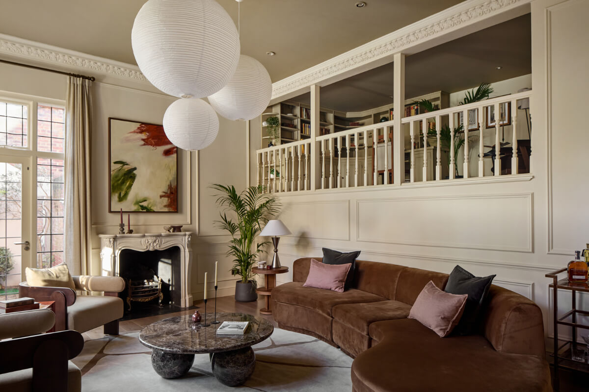 A Stunning Victorian House with Period Features and Surprising Spaces 1 living room curved brown sofa fireplace loft space