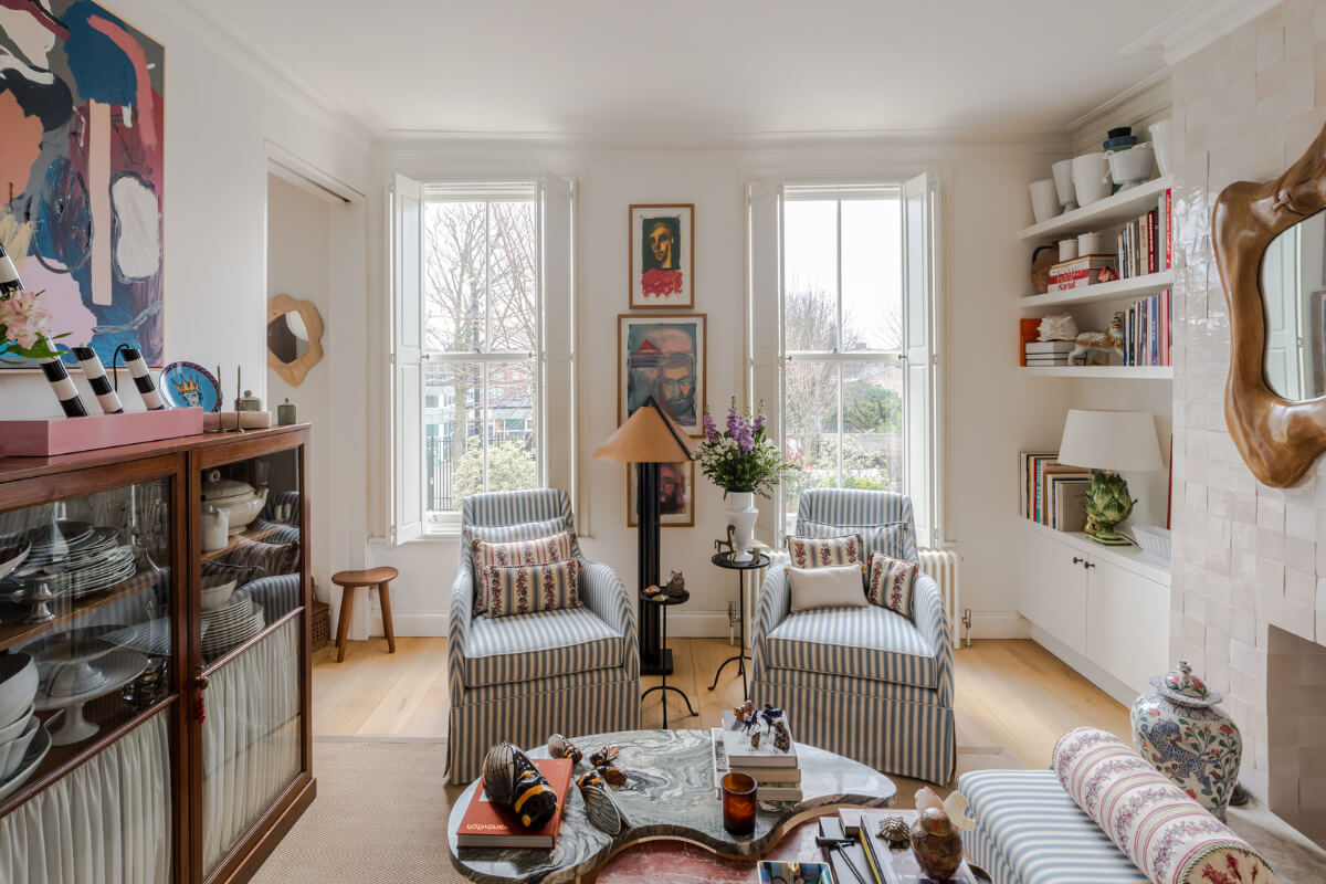 Cozy Contemporary Spaces in a Light-Filled Victorian Apartment 2 living room striped armchairs fireplace mantel pink zellige tiles