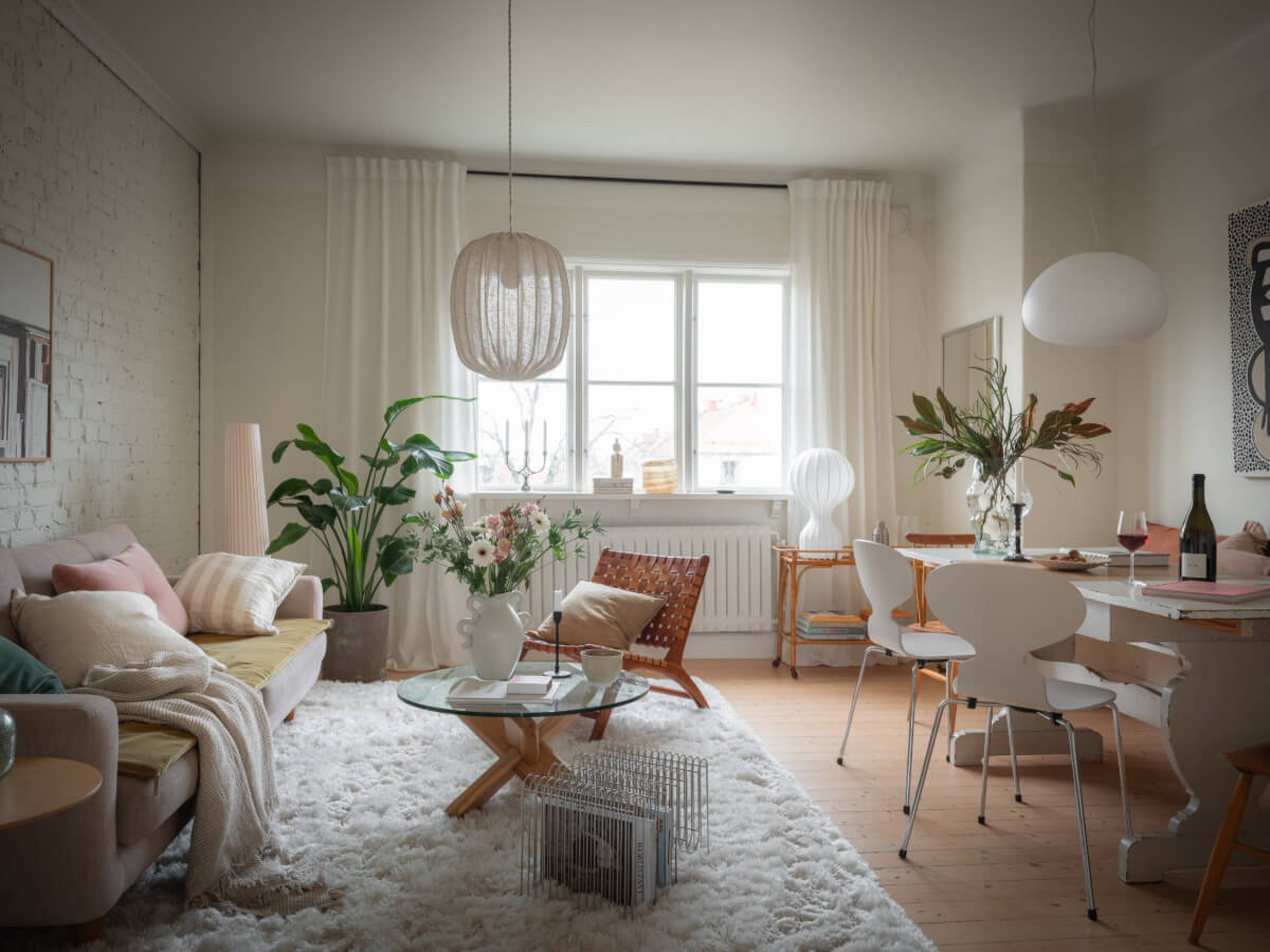A Renovated Duplex Apartment with Exposed Brick Walls 1 living room white painted brick wall nordroom