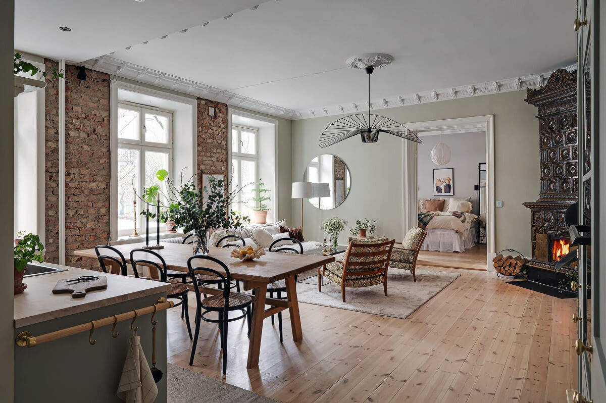 A Swedish Apartment with an Open Living Space and Period Features 1 open plan kitchen living room exposed brick fireplace