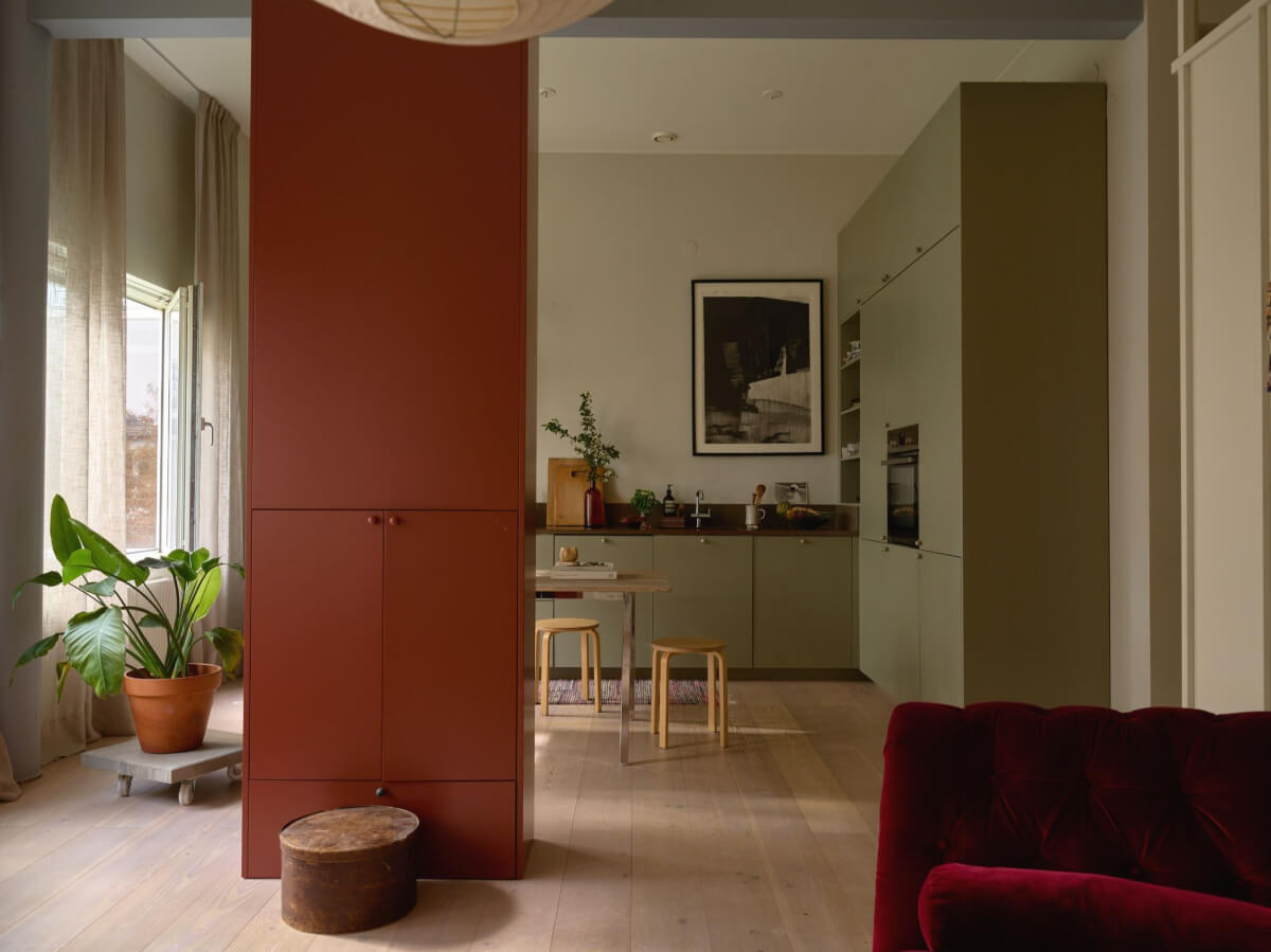 High Ceilings in a Small Swedish Loft Designed for a Family 9 open plan living space with custom cabinet room divider