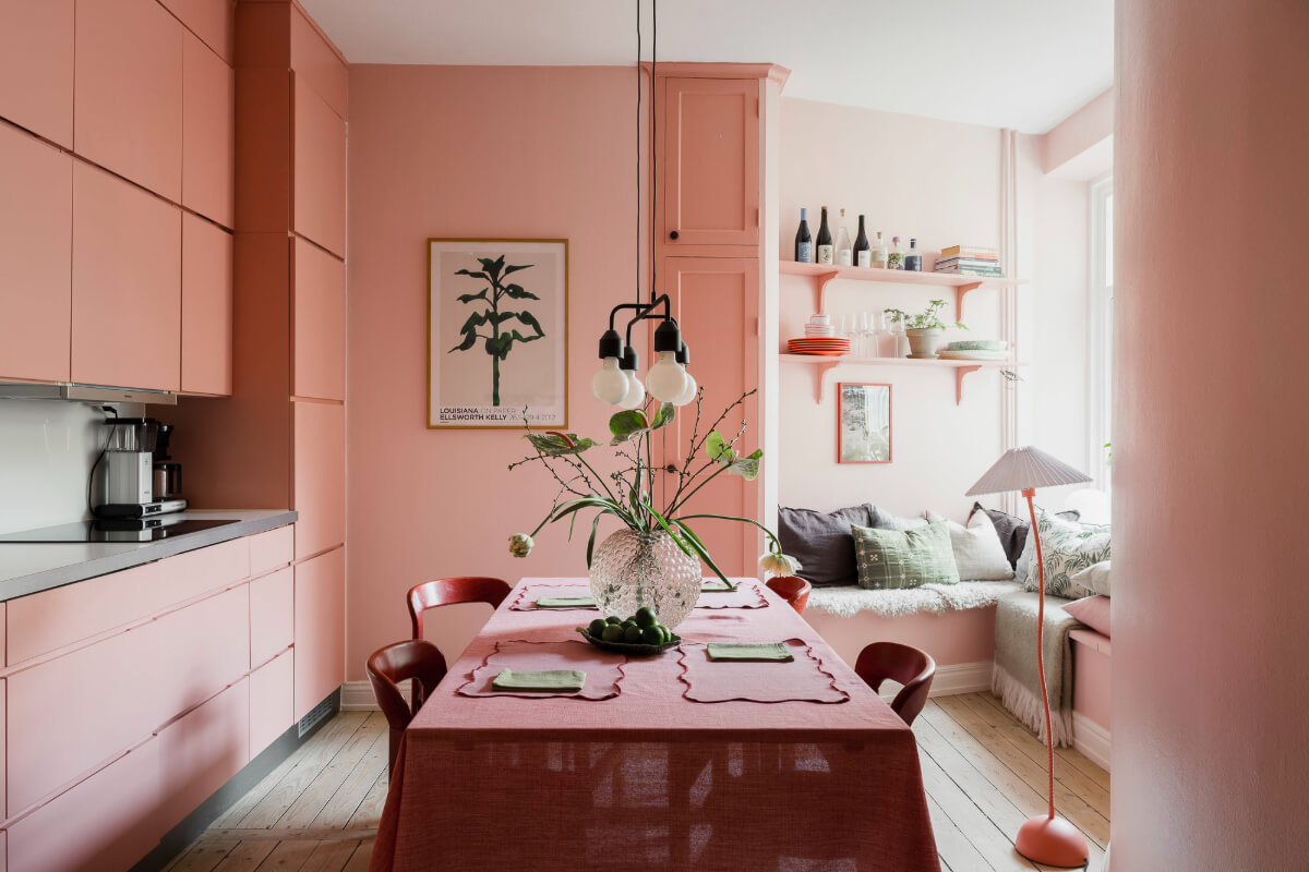 An Early 20th-Century Apartment with a Pink Kitchen 23 pink kitchen with dining table and window seat