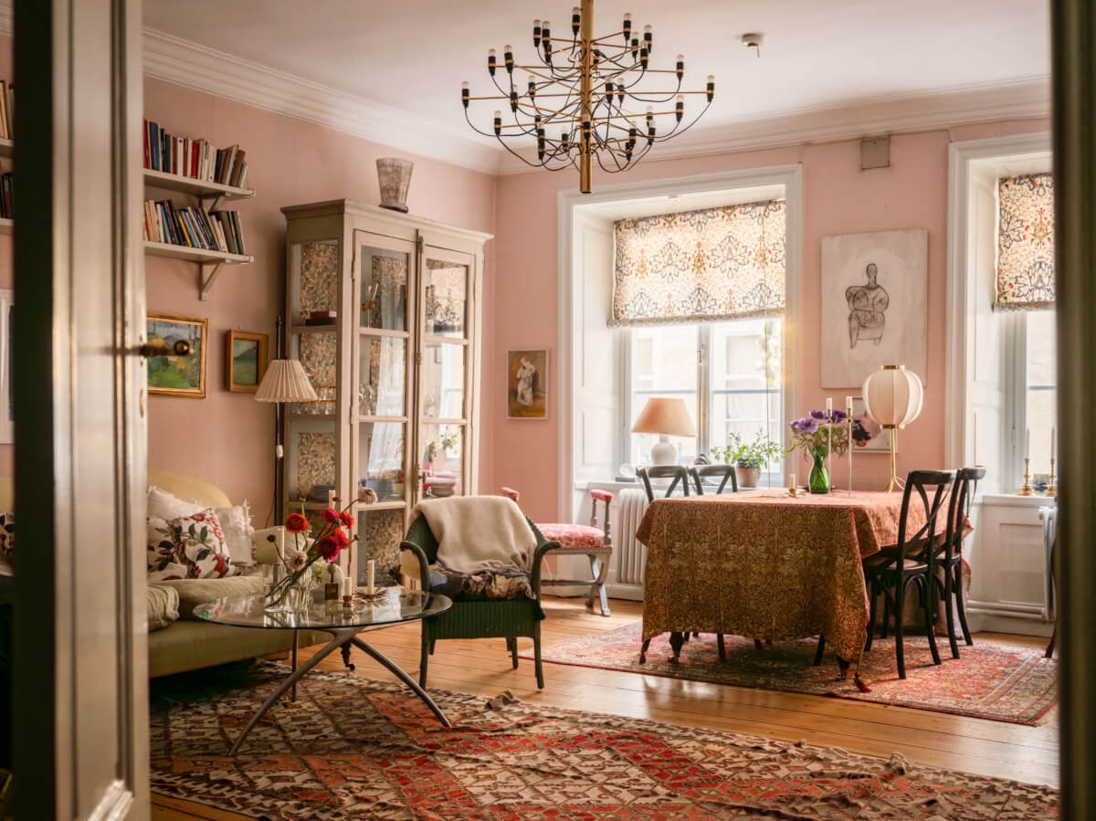 A Charming Home in a 17-Century Apartment in Stockholm's Old Town 1 pink living room textiles bookshelves