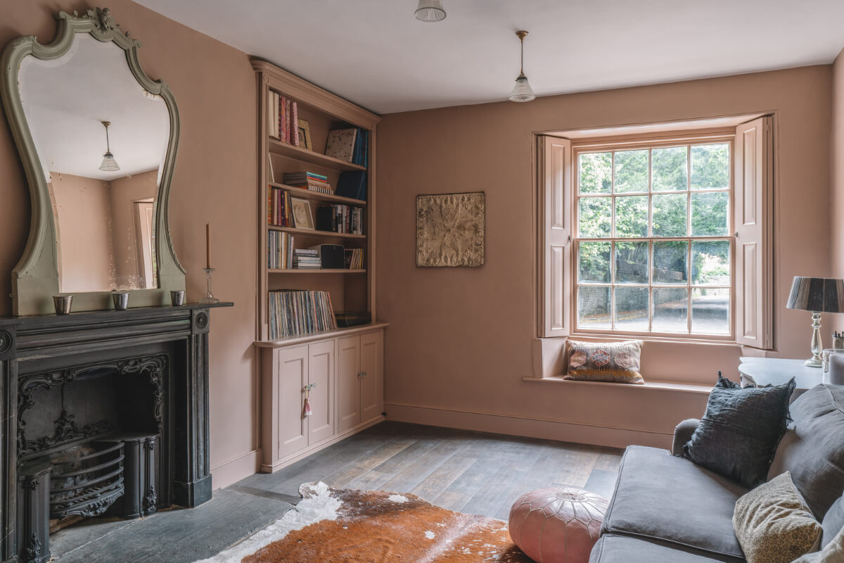 A Beautiful Renovated Country House in England 5 pink sitting room black fireplace window seat