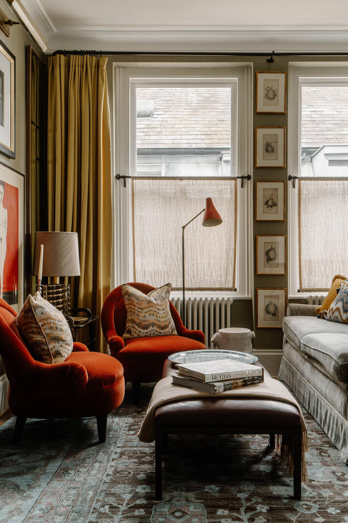 A Cozy Art-Filled Attic Apartment in London 4 red armchairs