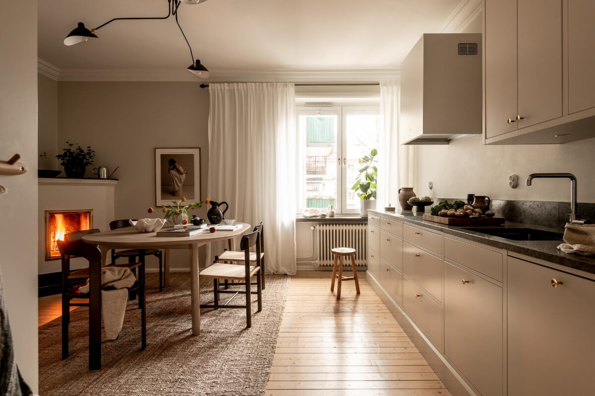 A Beautiful Calm 1920s Apartment in Gothenburg 9 serene kitchen with dining table and fireplace